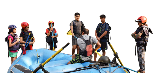 Children and instructor in a blue raft wearing helmets and life jackets
